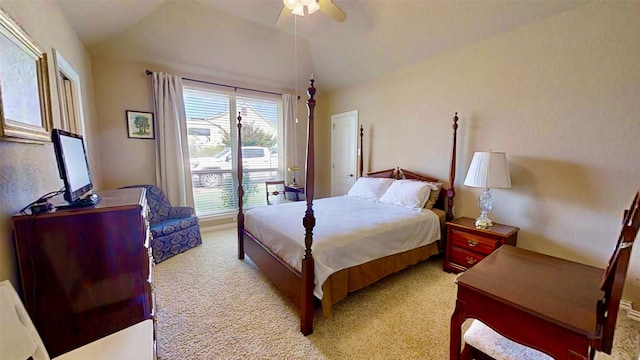 bedroom featuring vaulted ceiling, a ceiling fan, and light colored carpet