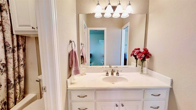 bathroom featuring vanity and shower / bathtub combination with curtain