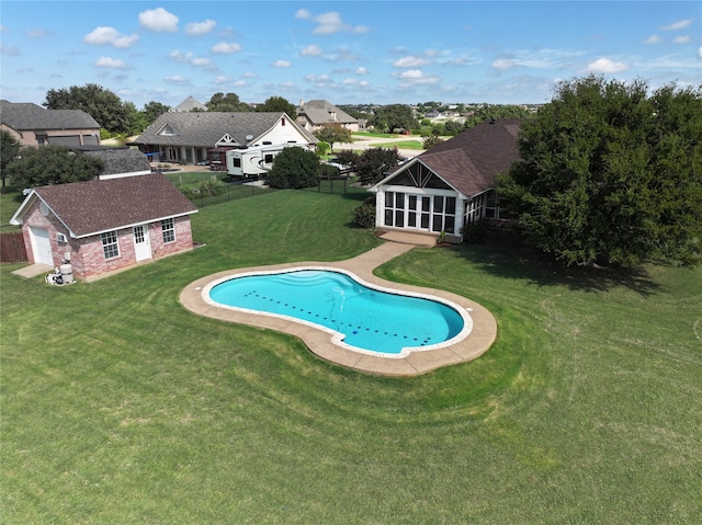 view of swimming pool with an outdoor structure and a yard