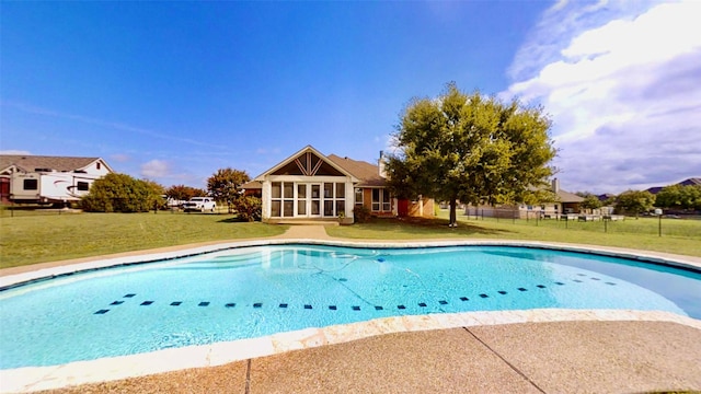 pool with fence and a lawn