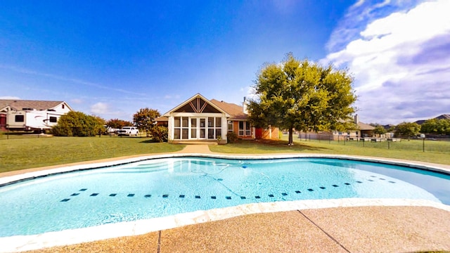 outdoor pool featuring a lawn and fence