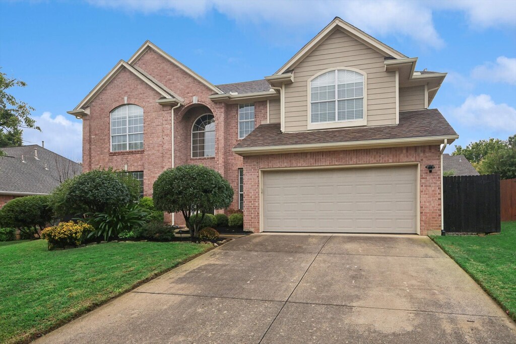 view of front property with a garage and a front yard