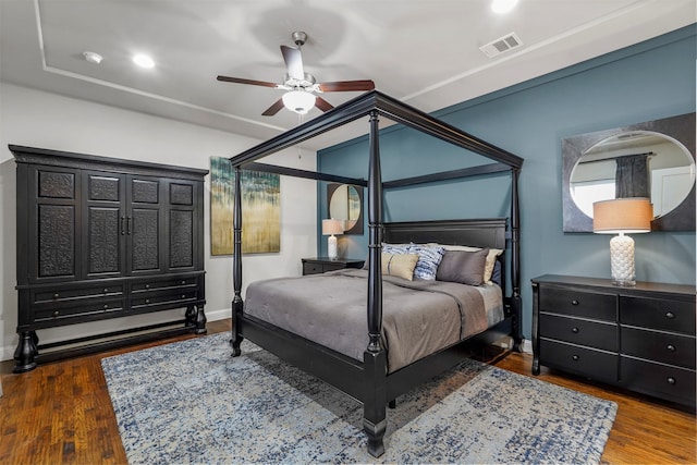 bedroom with dark hardwood / wood-style flooring and ceiling fan