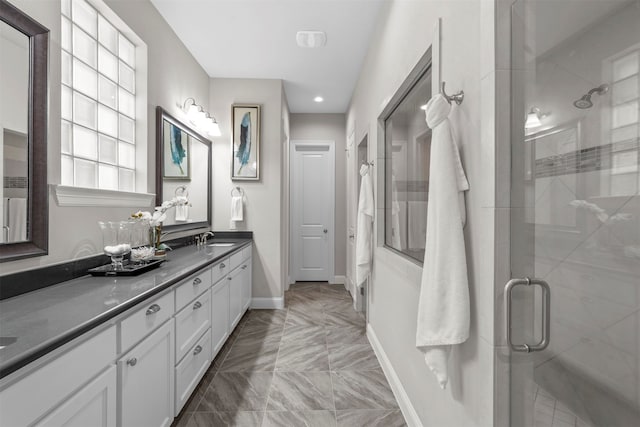 bathroom featuring an enclosed shower and vanity