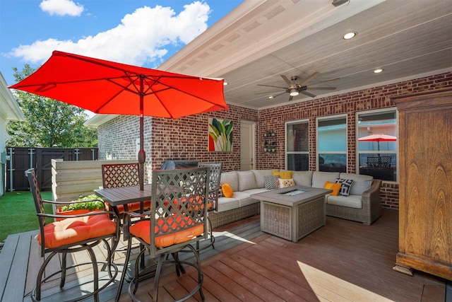 wooden deck featuring an outdoor hangout area and ceiling fan