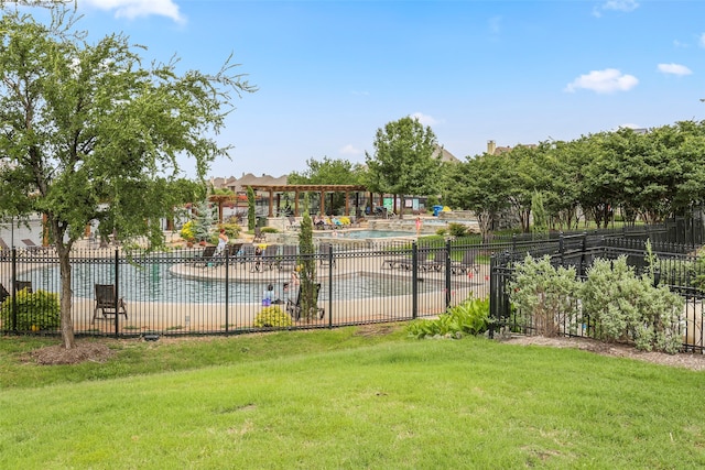 exterior space featuring a swimming pool and a lawn