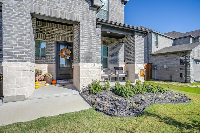 doorway to property with a yard and a patio area