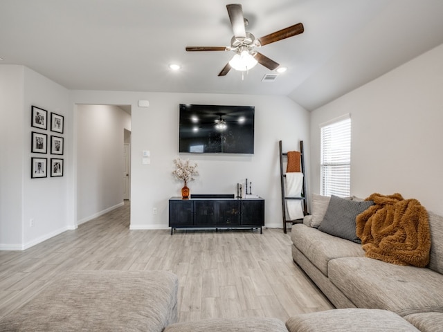 living room featuring light hardwood / wood-style floors, lofted ceiling, and ceiling fan