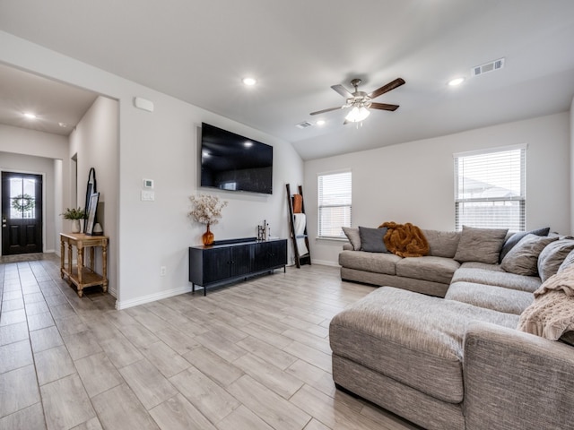 living room with ceiling fan and light hardwood / wood-style flooring