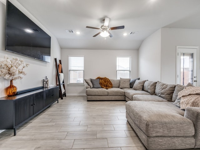 living room featuring light wood-type flooring, vaulted ceiling, and ceiling fan