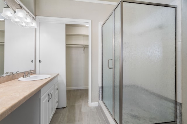 bathroom with walk in shower and vanity