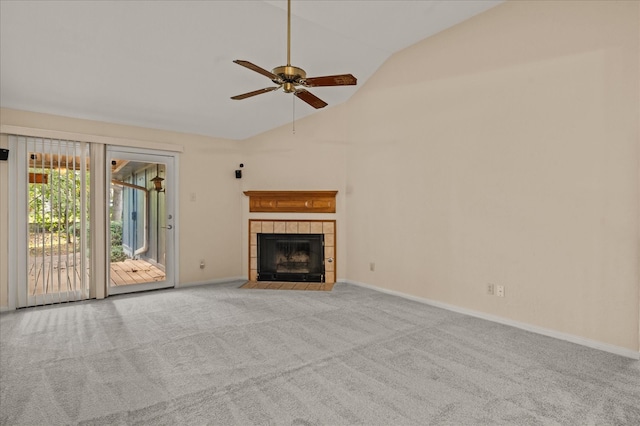 unfurnished living room featuring high vaulted ceiling, a tiled fireplace, light carpet, and ceiling fan