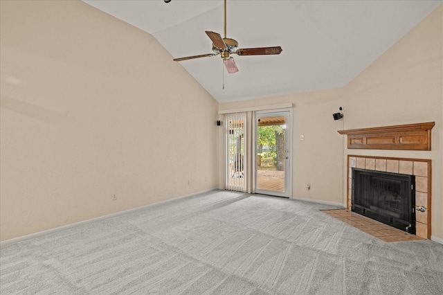 unfurnished living room with ceiling fan, light colored carpet, a tile fireplace, and high vaulted ceiling