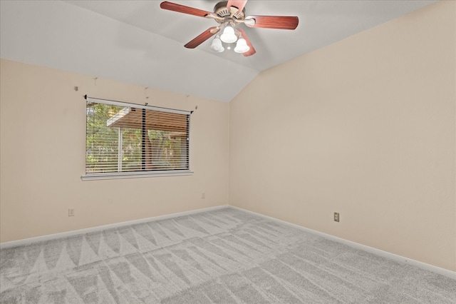 spare room with light colored carpet, lofted ceiling, and ceiling fan