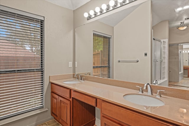 bathroom featuring vanity and an enclosed shower