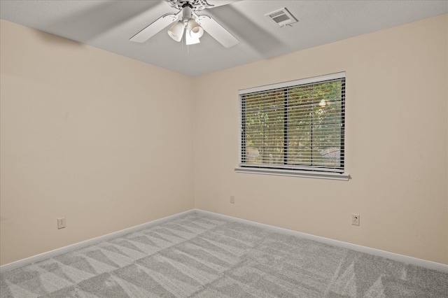 spare room with light carpet and ceiling fan