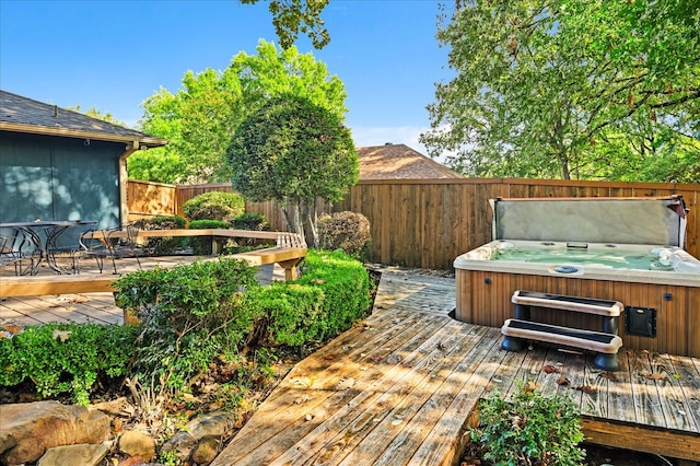 wooden terrace featuring a hot tub