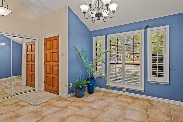 foyer entrance featuring lofted ceiling and an inviting chandelier