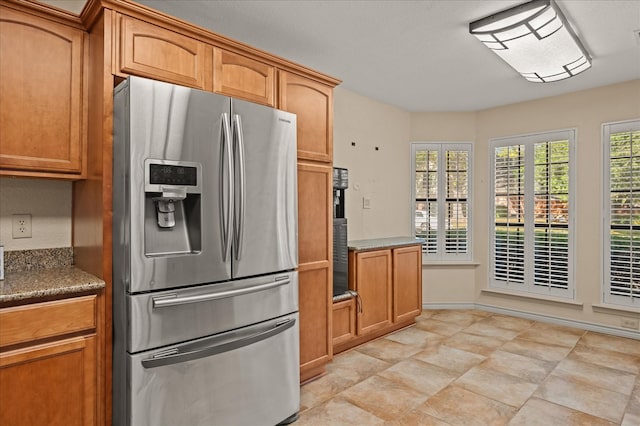 kitchen featuring stainless steel fridge with ice dispenser