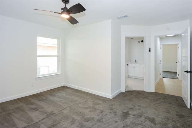 empty room with ceiling fan and carpet flooring