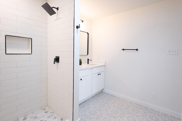 bathroom featuring a tile shower and vanity