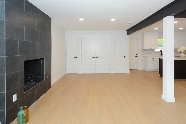 unfurnished living room featuring a fireplace and light wood-type flooring