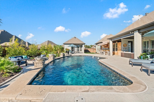 view of pool with an outdoor hangout area, a patio area, and pool water feature