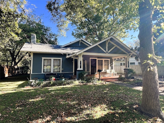 view of front of property with a porch and a front yard