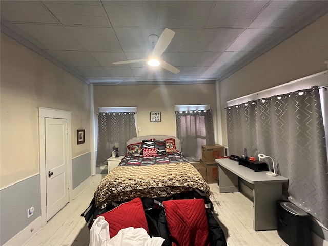 bedroom with light hardwood / wood-style floors and ceiling fan