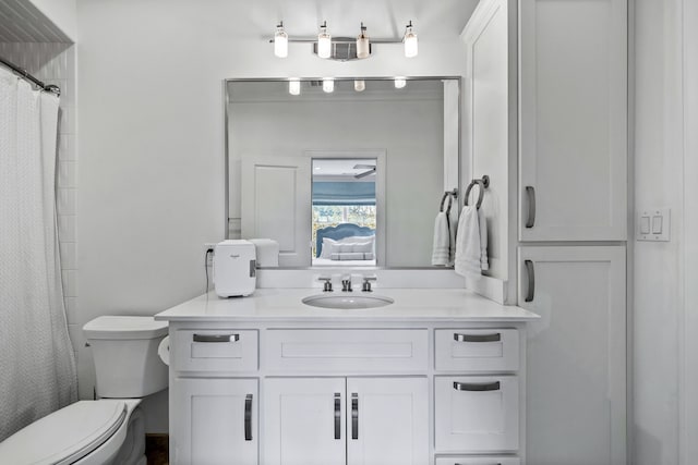 bathroom with vanity, toilet, and a shower with shower curtain