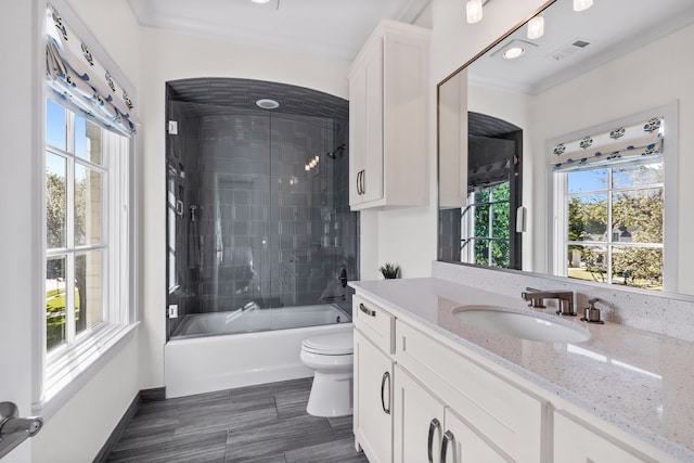 full bathroom with ornamental molding, bath / shower combo with glass door, vanity, and toilet