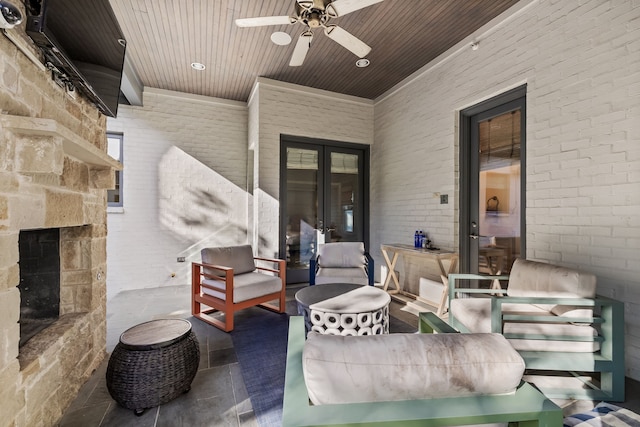 view of patio featuring ceiling fan and an outdoor stone fireplace