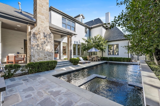 view of pool with a patio and pool water feature