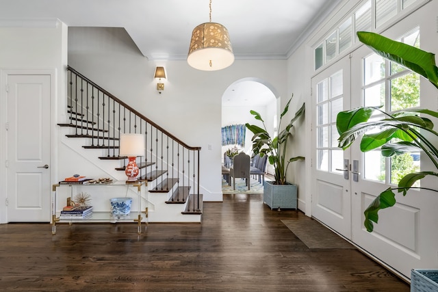 foyer featuring dark hardwood / wood-style flooring, french doors, and ornamental molding