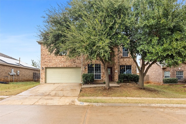 obstructed view of property with a garage, brick siding, and driveway