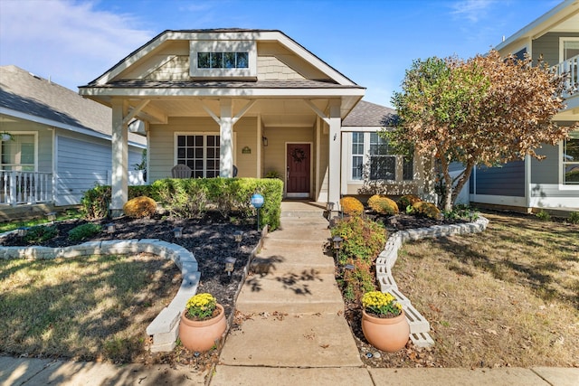 view of front of house featuring a porch and a front lawn