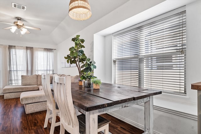 dining space featuring dark hardwood / wood-style flooring, lofted ceiling, and ceiling fan