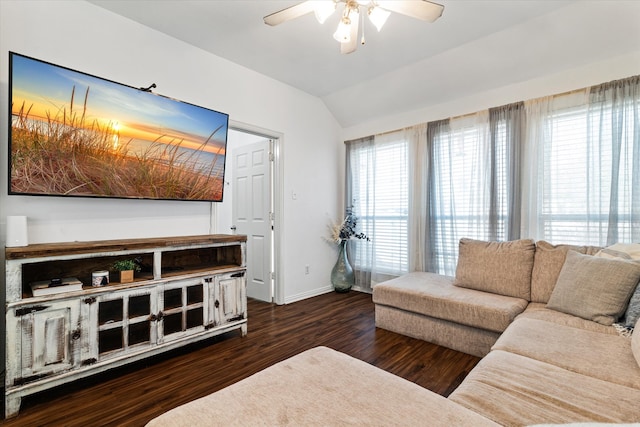 living room featuring plenty of natural light, lofted ceiling, dark wood-type flooring, and ceiling fan