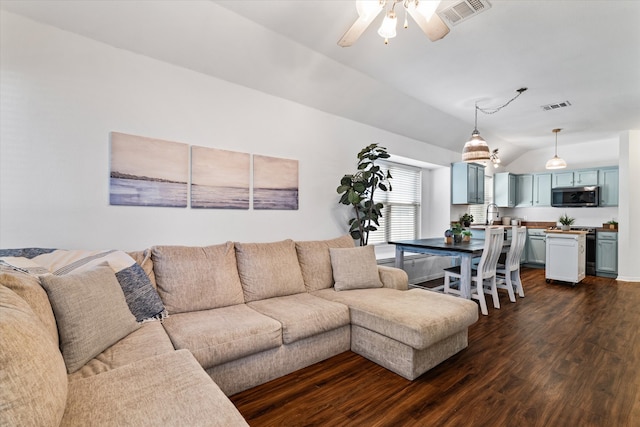 living room with vaulted ceiling, ceiling fan, sink, and dark hardwood / wood-style flooring