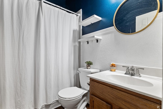 bathroom with toilet and vanity