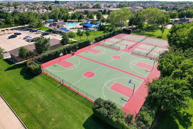 view of sport court featuring a lawn