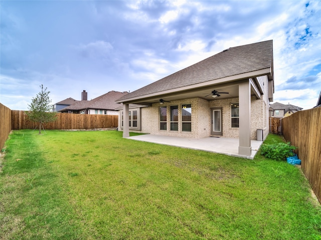 rear view of house featuring a ceiling fan, a shingled roof, and a patio