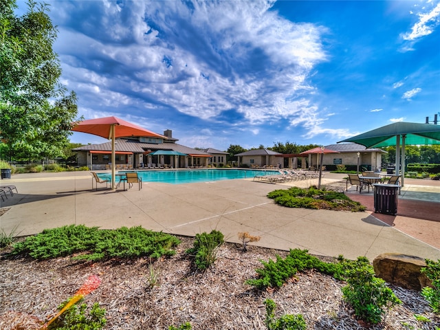 community pool with a gazebo and a patio area