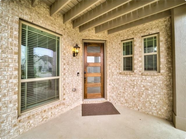 entrance to property with a patio area