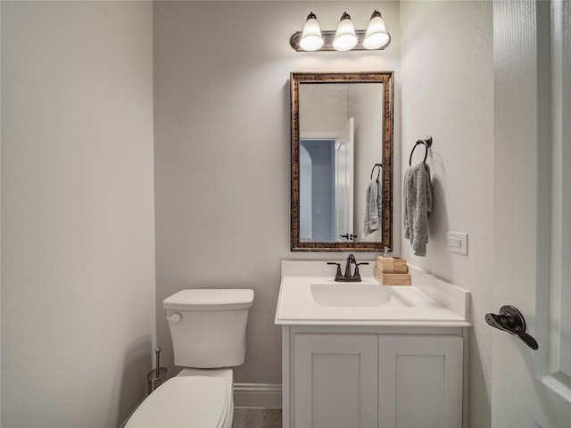 bathroom featuring toilet and vanity
