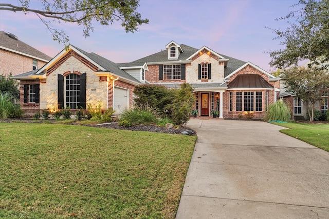 view of front of home with a lawn and a garage