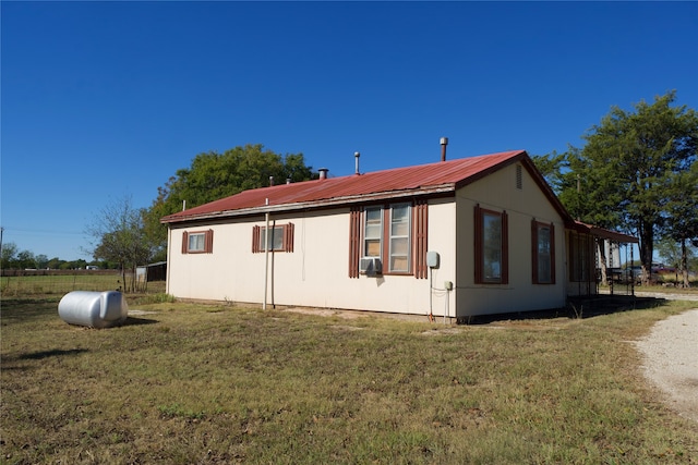 view of side of property with cooling unit and a yard