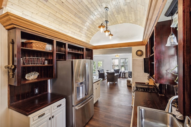 kitchen with dark hardwood / wood-style flooring, lofted ceiling, white cabinets, sink, and stainless steel fridge