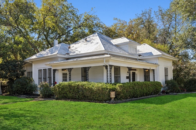 view of property exterior featuring a lawn and covered porch