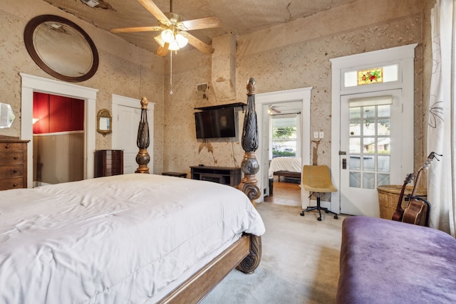 bedroom with ceiling fan, access to exterior, and carpet floors